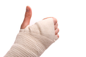 White medicine bandage on human injury hand. Studio isolated.