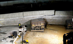 Vehicles are trapped underneath a bridge that collapsed while under construction in Belo Horizonte, July 3, 2014. The unfinished overpass collapsed in the Brazilian World Cup host city of Belo Horizonte on Thursday, killing at least one person and casting a shadow over a tournament that has suffered repeated construction accidents and delays. REUTERS/Ivan Alvarado (BRAZIL - Tags: SPORT SOCCER WORLD CUP DISASTER TRANSPORT)